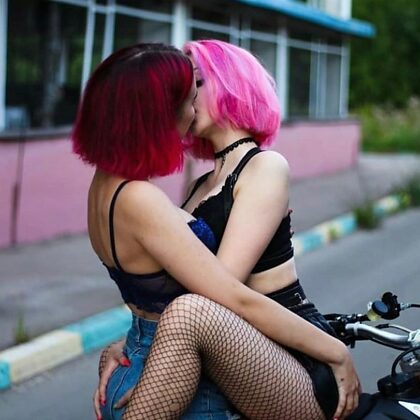 Girls kissing on bike