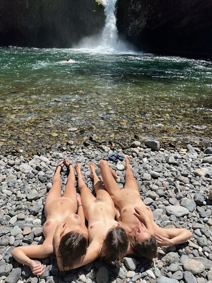 Sunbathing with my friends on the rocks after a dip in the waterfall
