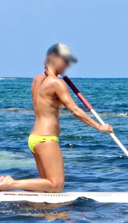 Topless paddleboarden