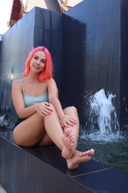 Pretty girl showing her feet in public place