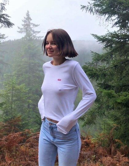 Posing for her boyfriend, braless, on a foggy day in the mountains.