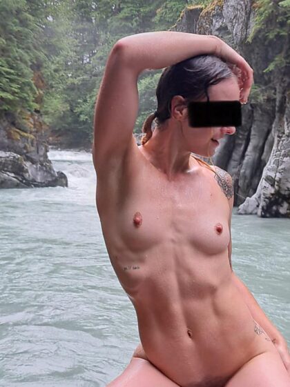 Showing off completely naked by the river